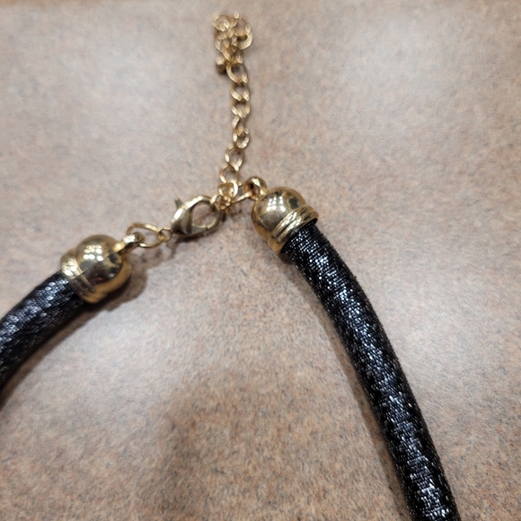 Black rope necklace with gold medal, black, and gray circle. - Picture 2 of 6